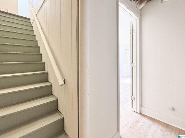 staircase with wood finished floors and baseboards