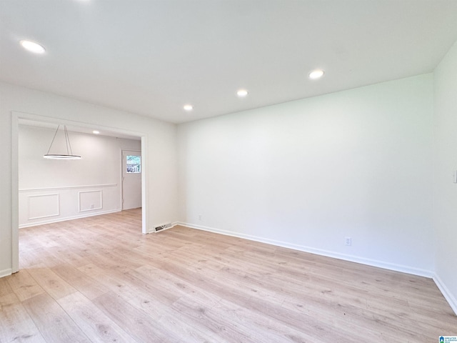 spare room with light wood-type flooring and recessed lighting
