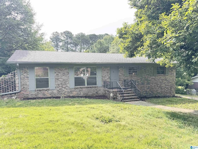 single story home with brick siding and a front yard