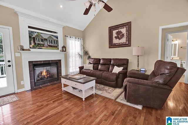 201 Paw Path Ln, Blountsville, AL 35031 - living room featuring ceiling fan, wood finished floors, vaulted ceiling, a tile fireplace, and crown molding