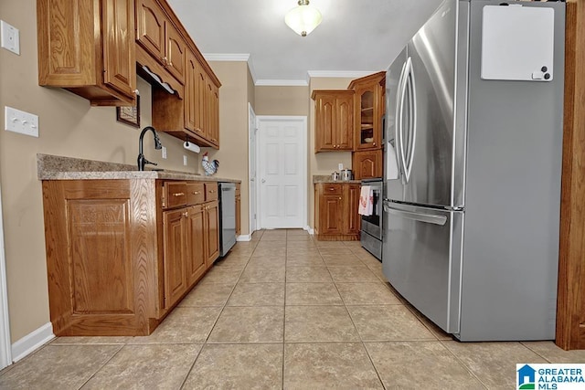 201 Paw Path Ln, Blountsville, AL 35031 - kitchen featuring stainless steel appliances, crown molding, light tile patterned flooring, brown cabinets, and baseboards