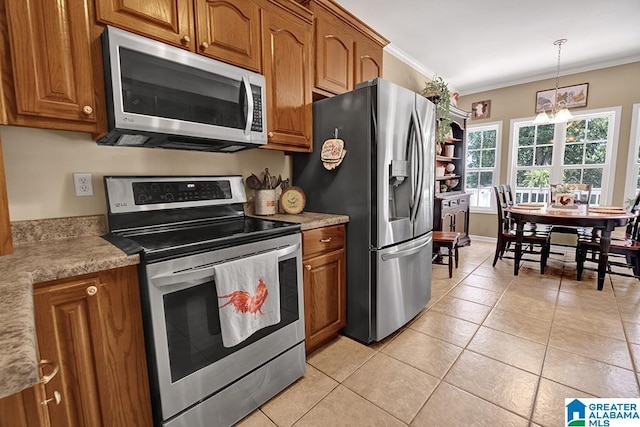 201 Paw Path Ln, Blountsville, AL 35031 - kitchen featuring appliances with stainless steel finishes, brown cabinetry, light tile patterned floors, crown molding, and light countertops