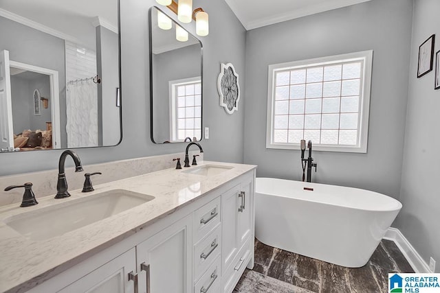 201 Paw Path Ln, Blountsville, AL 35031 - bathroom featuring ornamental molding, double vanity, a freestanding tub, and baseboards