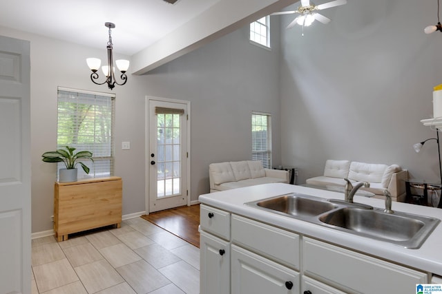 452 Cambrian Ridge Trl, Pelham, AL 35124 - kitchen featuring a sink, plenty of natural light, a ceiling fan, a chandelier, and a high ceiling