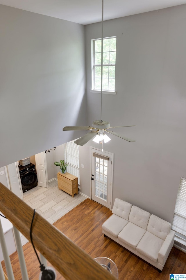 452 Cambrian Ridge Trl, Pelham, AL 35124 - living area with light wood-style floors, a ceiling fan, washer / clothes dryer, and baseboards