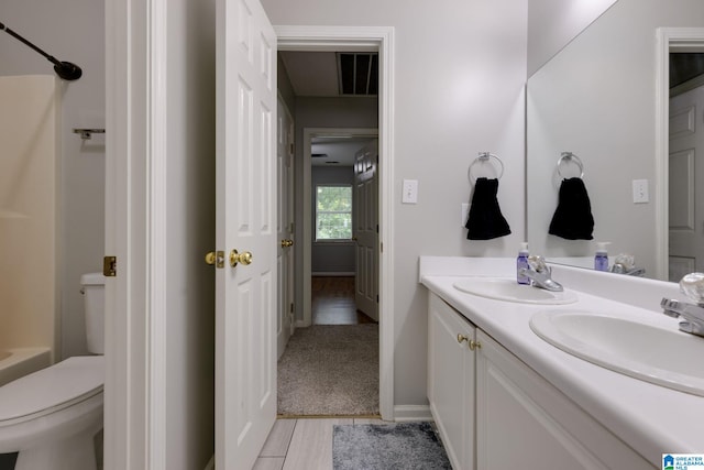 452 Cambrian Ridge Trl, Pelham, AL 35124 - bathroom featuring toilet, double vanity, a shower, wood finished floors, and baseboards