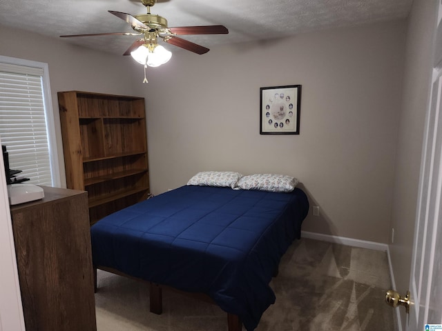 carpeted bedroom featuring a textured ceiling, baseboards, and ceiling fan