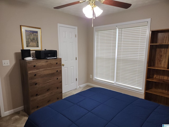 carpeted bedroom with baseboards and ceiling fan