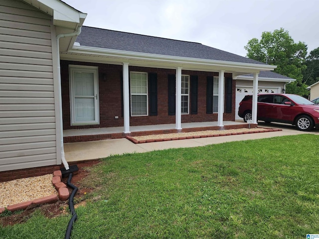 ranch-style home featuring a front lawn, a porch, a garage, brick siding, and roof with shingles
