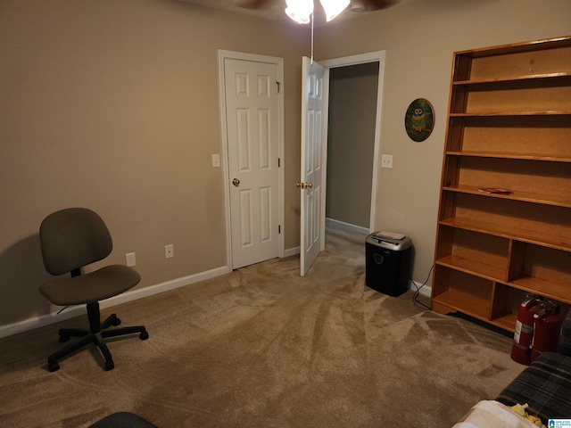 home office with carpet floors, a ceiling fan, and baseboards