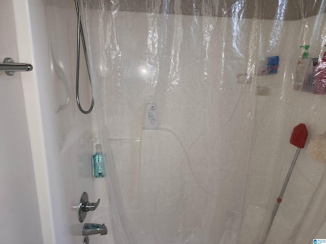 bathroom view of shower / bath combination with curtain