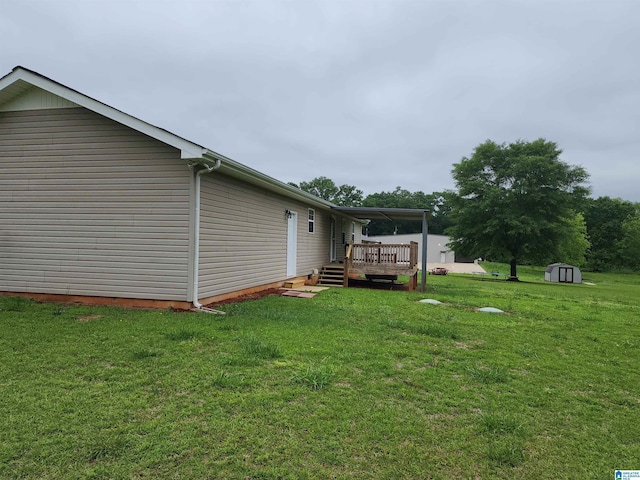 view of home's exterior with a storage shed, a deck, an outbuilding, and a lawn
