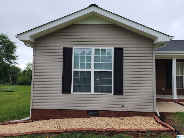 view of property exterior featuring a lawn and crawl space