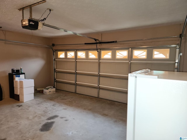 garage with a garage door opener and freestanding refrigerator