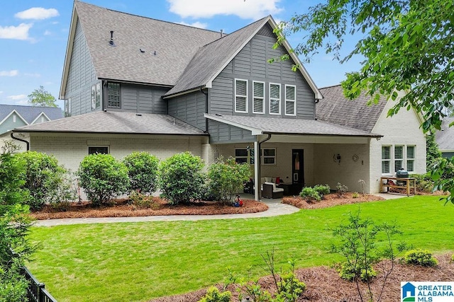 2126 Raines Run, Birmingham, AL 35242 - back of property featuring a shingled roof, a patio area, and a lawn