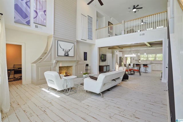 2126 Raines Run, Birmingham, AL 35242 - living room featuring a high ceiling, a ceiling fan, wood finished floors, and a fireplace