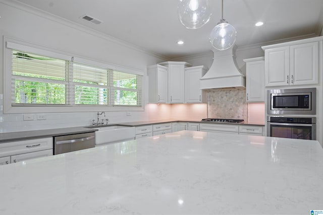 2126 Raines Run, Birmingham, AL 35242 - kitchen with appliances with stainless steel finishes, ornamental molding, tasteful backsplash, white cabinets, and a sink