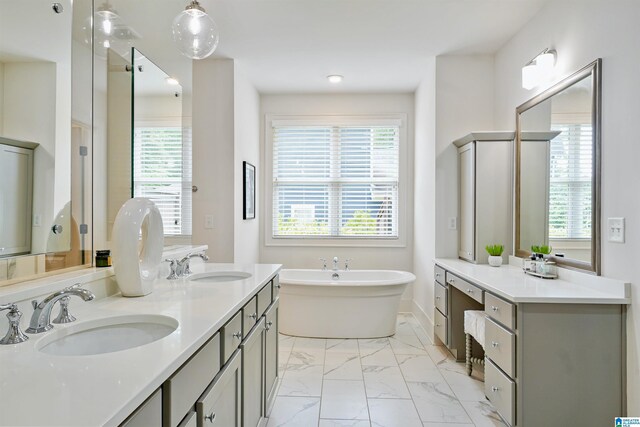 2126 Raines Run, Birmingham, AL 35242 - bathroom featuring marble look tiles, a soaking tub, plenty of natural light, and double vanity