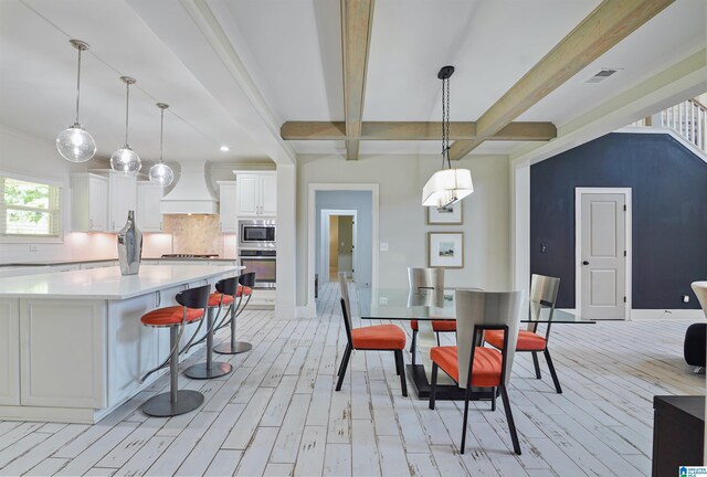 2126 Raines Run, Birmingham, AL 35242 - dining area featuring light wood-style flooring, beamed ceiling, and baseboards