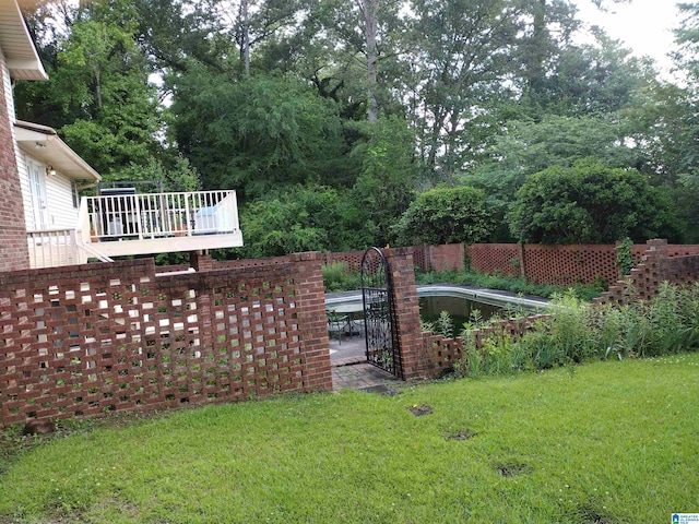 view of grassy yard featuring a deck