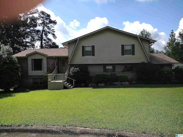 view of front of house featuring a front yard and brick siding