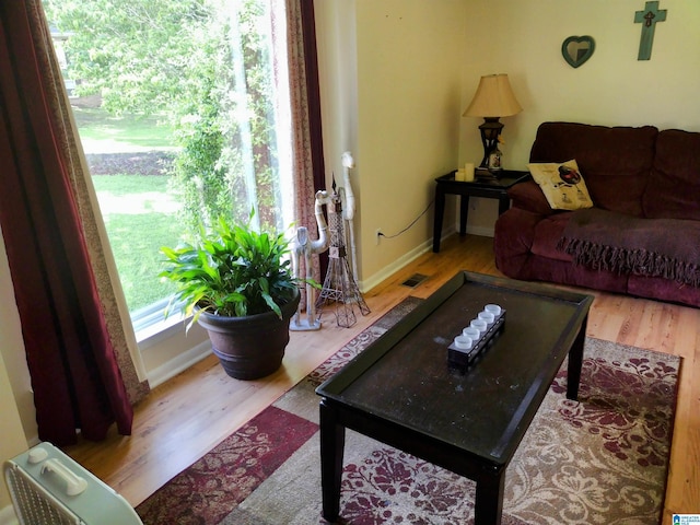 living area with wood finished floors and baseboards