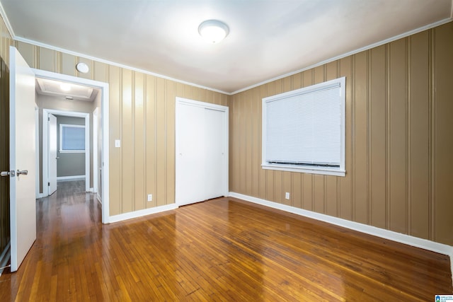 2444 4th St, Birmingham, AL 35215 - unfurnished bedroom with ornamental molding, hardwood / wood-style floors, a closet, and baseboards