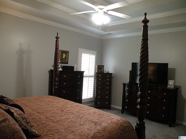 carpeted bedroom featuring crown molding, a raised ceiling, ceiling fan, and baseboards