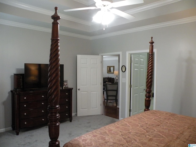 bedroom with ornamental molding, light colored carpet, and a ceiling fan