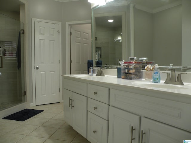 full bath with crown molding, tile patterned floors, a stall shower, and double vanity