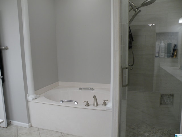 full bath featuring a shower stall, tile patterned flooring, and a bath