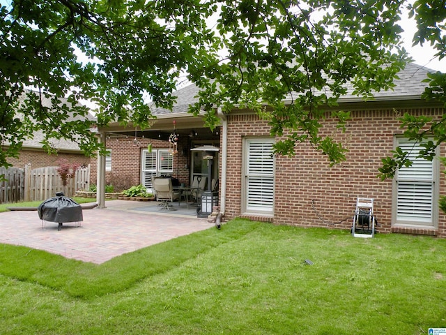 back of property featuring a fire pit, a patio area, brick siding, and roof with shingles