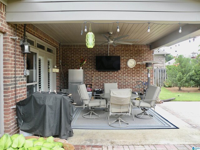 view of patio featuring a ceiling fan, outdoor dining area, and area for grilling
