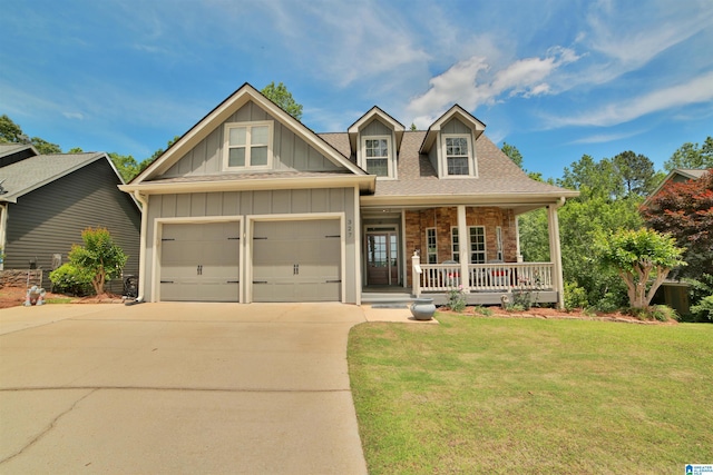 craftsman inspired home with board and batten siding, a porch, driveway, a front yard, and roof with shingles