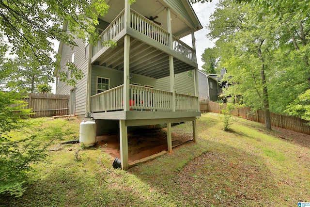 back of property with a fenced backyard and a wooden deck