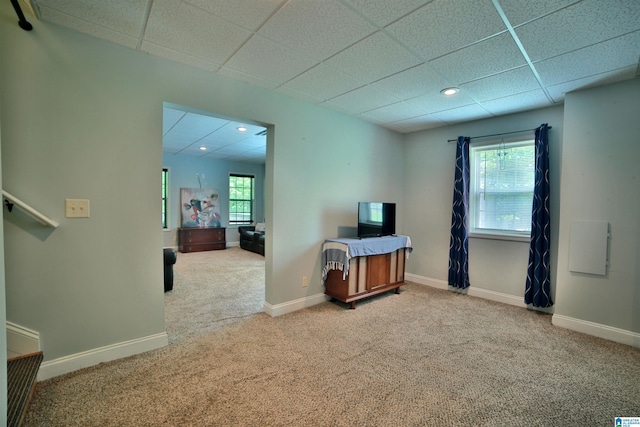 carpeted spare room featuring a drop ceiling, recessed lighting, and baseboards