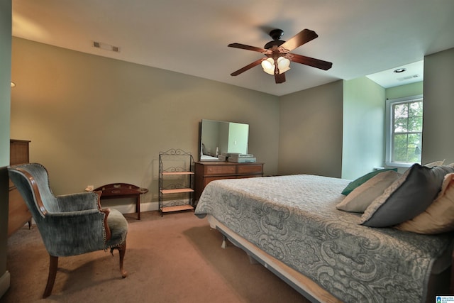 carpeted bedroom featuring baseboards and ceiling fan