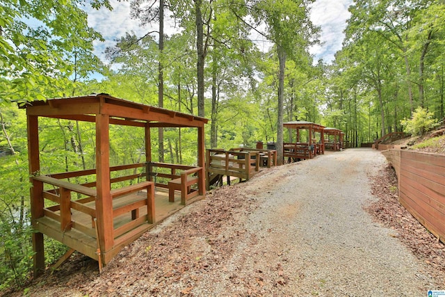 view of community featuring a gazebo and a wooded view