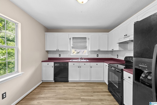 5826 Willow Crest Dr, Pinson, AL 35126 - kitchen with black appliances, a sink, dark countertops, under cabinet range hood, and a textured ceiling
