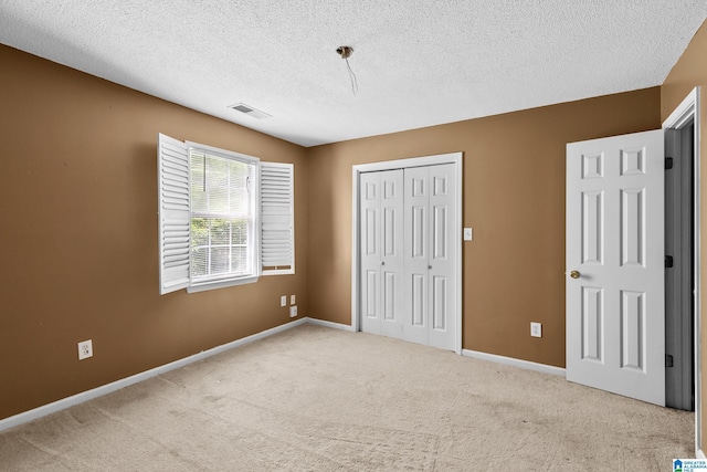 5826 Willow Crest Dr, Pinson, AL 35126 - unfurnished bedroom with a closet, a textured ceiling, carpet, and baseboards