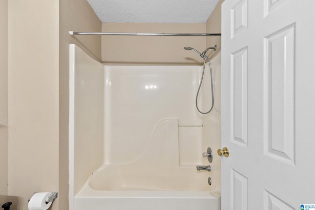 5826 Willow Crest Dr, Pinson, AL 35126 - bathroom featuring a textured ceiling and bathing tub / shower combination