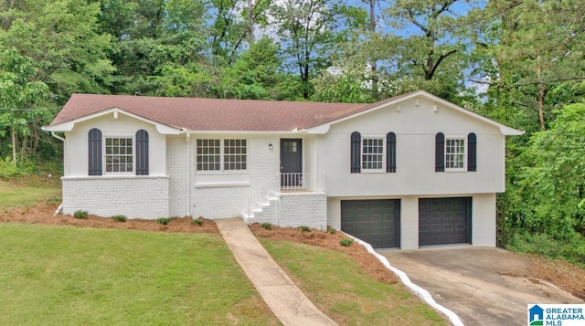 view of front of home with brick siding, a garage, concrete driveway, and a front yard