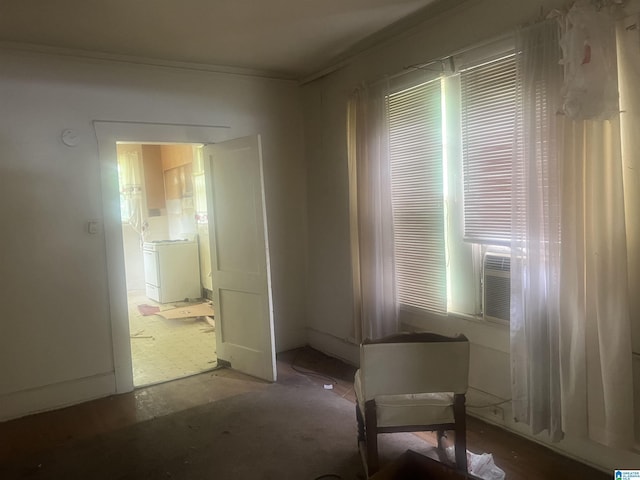 unfurnished dining area featuring washer / dryer and ornamental molding