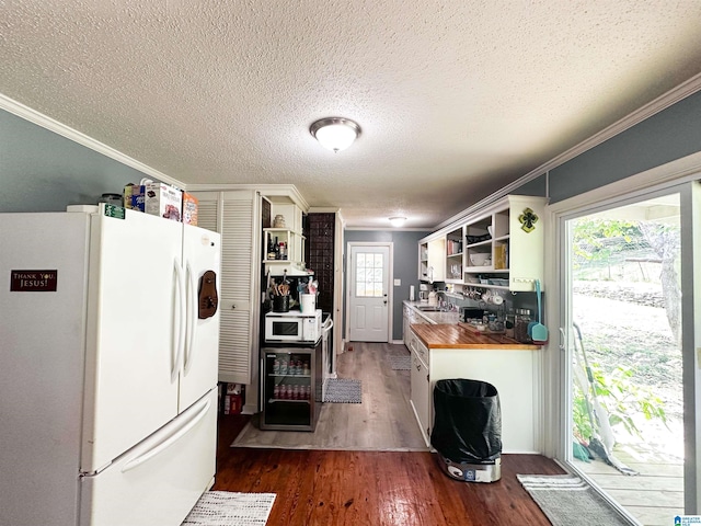 18981 Remlap Dr, Remlap, AL 35133 - kitchen featuring white appliances, open shelves, crown molding, dark wood-type flooring, and a textured ceiling