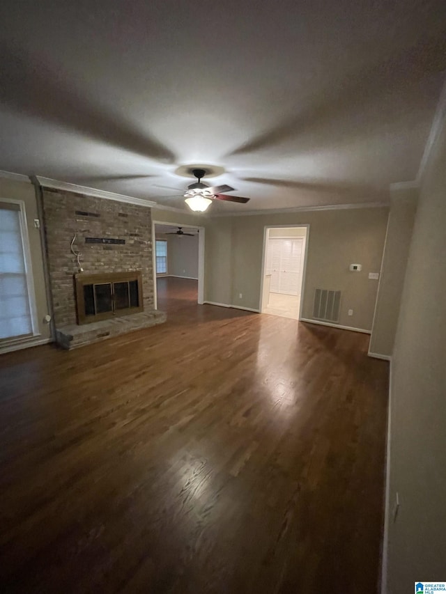 18981 Remlap Dr, Remlap, AL 35133 - unfurnished living room featuring crown molding, ceiling fan, wood finished floors, baseboards, and a large fireplace