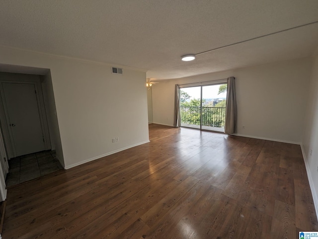 2407 Arlington Cres Unit C, Birmingham, AL 35205 - unfurnished room with dark wood finished floors, baseboards, and a textured ceiling