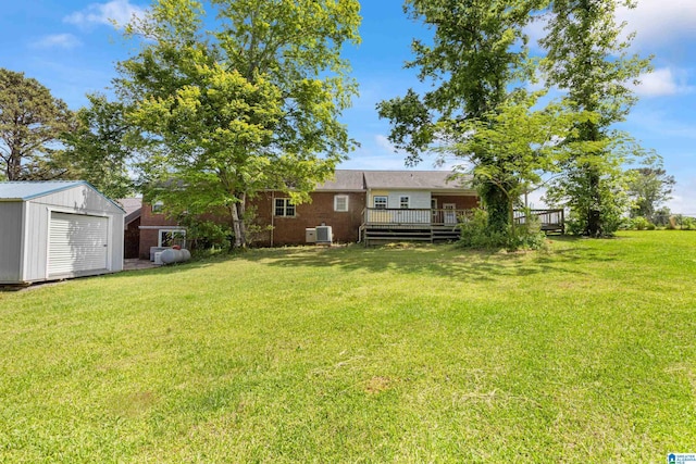 390 Chamblee Ln, Warrior, AL 35180 - view of grassy yard with a storage shed, a wooden deck, an outbuilding, and central AC