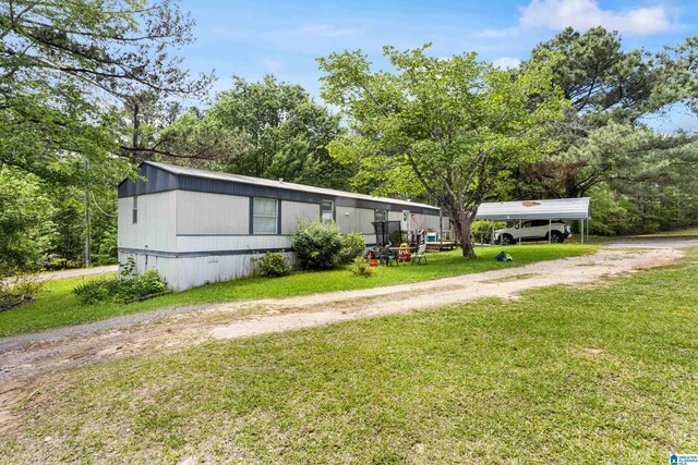 390 Chamblee Ln, Warrior, AL 35180 - manufactured / mobile home with dirt driveway, a detached carport, and a front yard