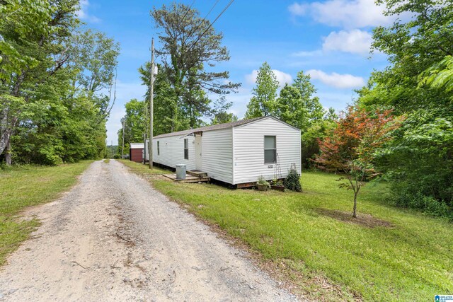 390 Chamblee Ln, Warrior, AL 35180 - view of side of property featuring driveway, a lawn, and an outbuilding