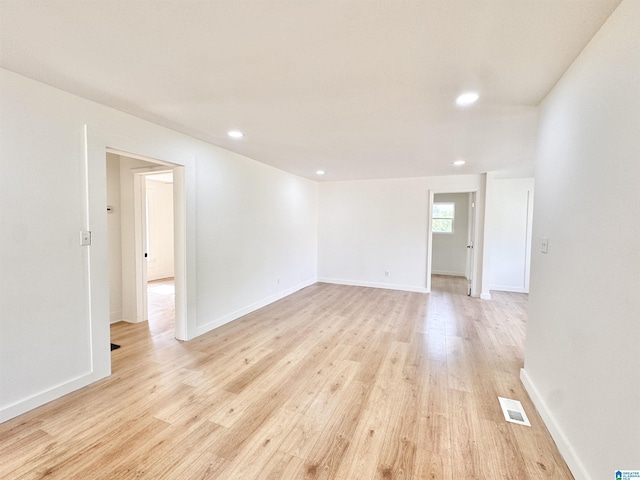 empty room featuring light wood-style flooring, recessed lighting, and baseboards